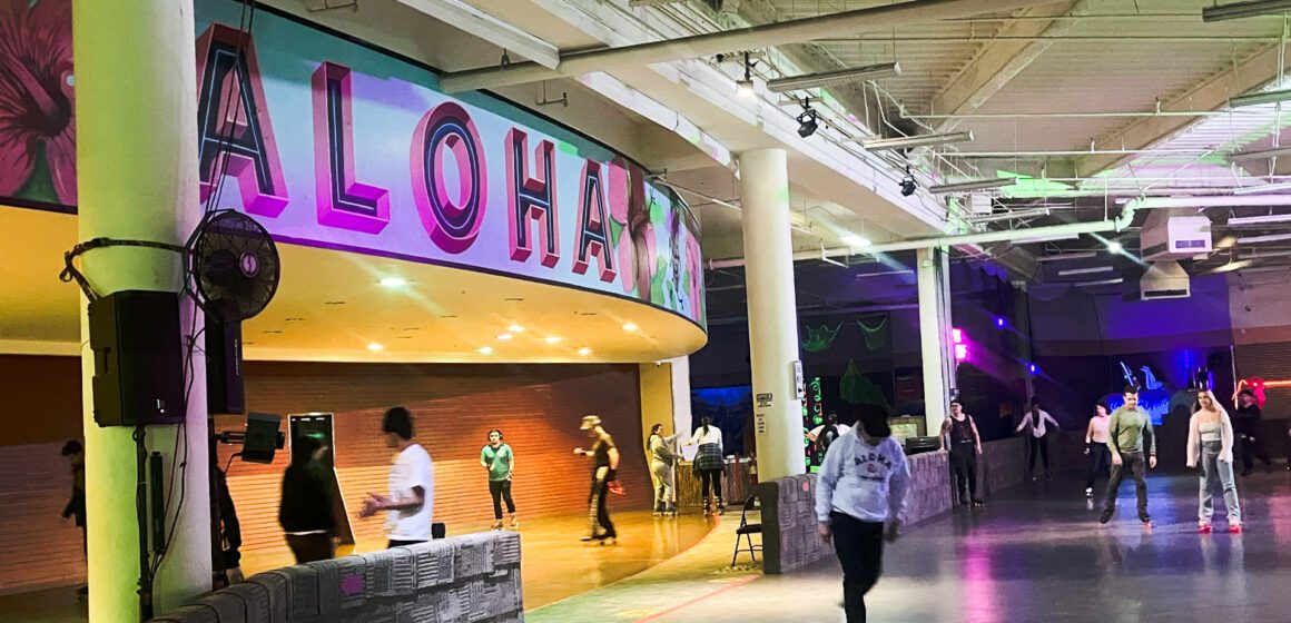 People skating at an indoor roller rink