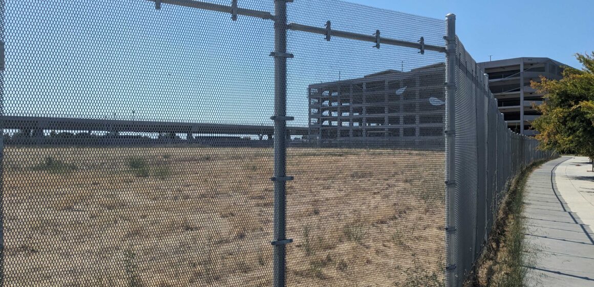 A plot of land behind a fence