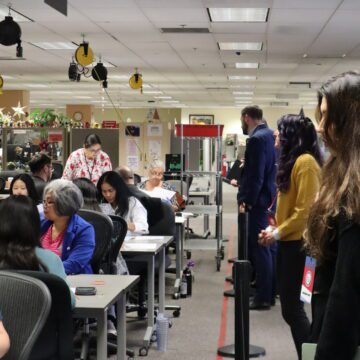 Election observers watch workers manually count voter ballots