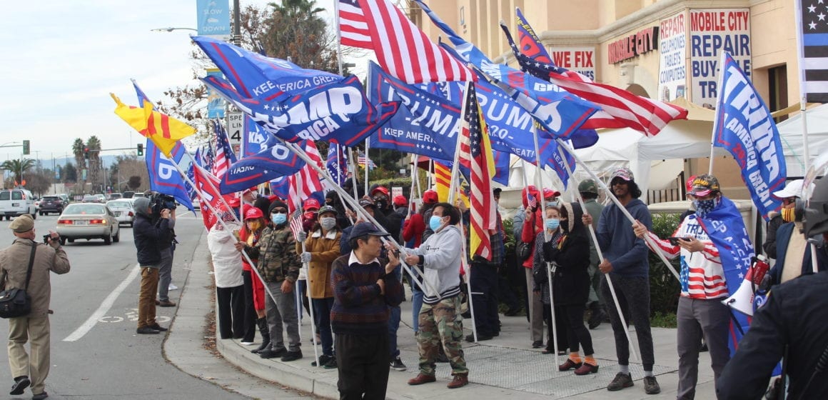 Supporters of President Donal Trump wave flags outside