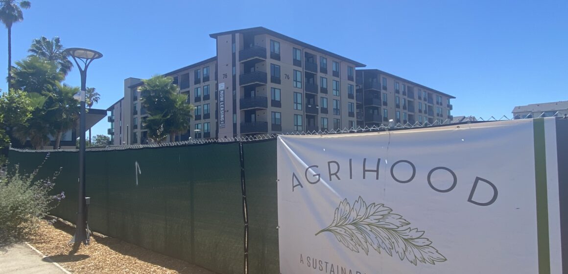 A chain fence in front of a housing complex