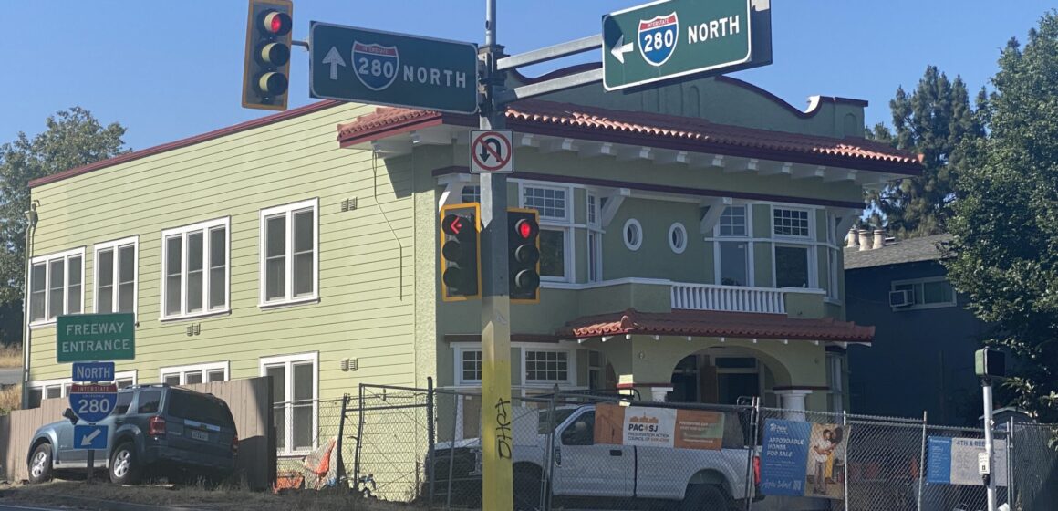 A street corner with an apartment complex in the background