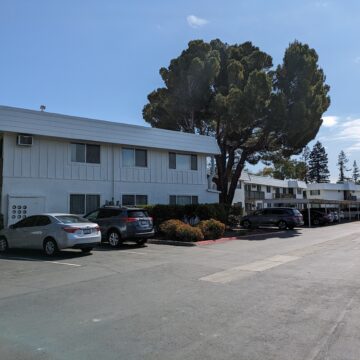 A two-story white apartment complex