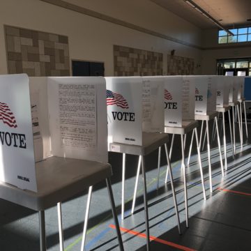 A row of voting booths on Election Day